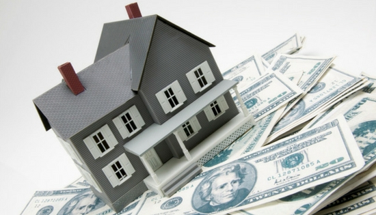 house sitting on a pile of money