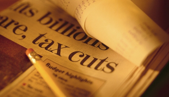 newspaper with title saying tax cuts