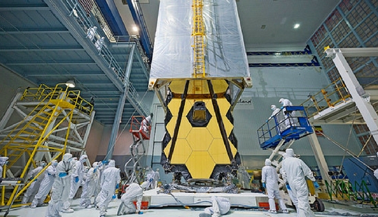 NASA workers standing around the James Webb Space Telescope