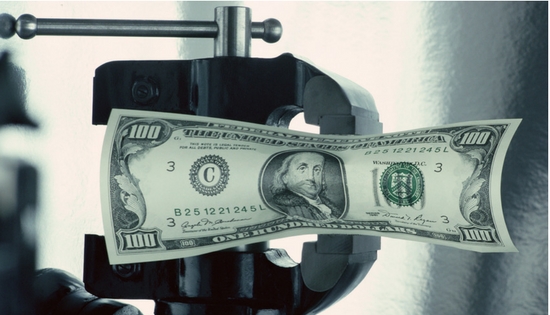 100 dollar bill being squeezed in a vice