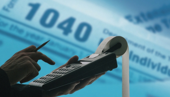 1040 tax form and someone using a calculator