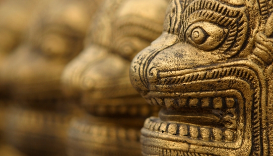 a line of asian dragon statue faces